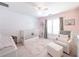 Charming Bedroom with soft pink tones, featuring a crib, comfortable seating, and natural light at 9195 Tuckerbrook Ln, Alpharetta, GA 30022
