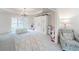 Well-lit bonus room featuring a chandelier, built-in cabinets and storage, a patterned rug, and a comfortable chair at 9195 Tuckerbrook Ln, Alpharetta, GA 30022