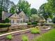 Beautiful home with manicured landscaping, lush lawn, and charming curb appeal at 9195 Tuckerbrook Ln, Alpharetta, GA 30022