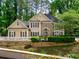Charming two-story home featuring a stone facade, manicured landscaping, and a welcoming entrance at 9195 Tuckerbrook Ln, Alpharetta, GA 30022