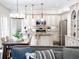 Open kitchen and dining area, featuring stainless steel appliances and granite countertops at 9195 Tuckerbrook Ln, Alpharetta, GA 30022
