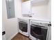 Efficient laundry room with modern washer and dryer setup, maximizing space with upper cabinets at 9195 Tuckerbrook Ln, Alpharetta, GA 30022