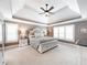 Elegant main bedroom with tray ceiling, plush carpet, and bright windows offers a relaxing retreat at 9195 Tuckerbrook Ln, Alpharetta, GA 30022