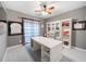 Home office with ceiling fan, gray walls, large desk, and custom shelves and cabinets at 9195 Tuckerbrook Ln, Alpharetta, GA 30022