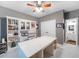 Home office boasts built-in shelving, a spacious white desk, and a view into the bathroom at 9195 Tuckerbrook Ln, Alpharetta, GA 30022