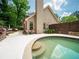 Sparkling pool with stone accents and lush greenery, creating a serene outdoor oasis at 9195 Tuckerbrook Ln, Alpharetta, GA 30022