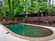 Backyard pool with wood fence and landscaped surroundings, offering a private retreat at 9195 Tuckerbrook Ln, Alpharetta, GA 30022
