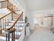 Elegant staircase with wrought iron spindles, with a view into a bright living room at 9195 Tuckerbrook Ln, Alpharetta, GA 30022