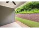 A well-maintained backyard features a sturdy retaining wall and fresh green grass at 131 Prominence Ct, Canton, GA 30114