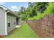Exterior backyard view with retaining wall and green lawn at 131 Prominence Ct, Canton, GA 30114
