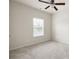 The bedroom offers neutral walls, cozy carpet, and a window that fills the space with natural light at 131 Prominence Ct, Canton, GA 30114