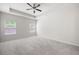Spacious bedroom featuring a tray ceiling, neutral carpet, and lots of natural light at 131 Prominence Ct, Canton, GA 30114