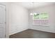 Bright dining room with a large window, wood-look floors, and modern trimwork at 131 Prominence Ct, Canton, GA 30114