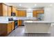 This kitchen features stainless steel appliances, wood cabinets, and granite counters for a sleek look at 131 Prominence Ct, Canton, GA 30114