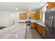 Modern kitchen features stainless steel appliances, wood cabinets, granite counters, and a large island for cooking at 131 Prominence Ct, Canton, GA 30114