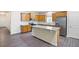 Spacious kitchen with stainless steel appliances, wood cabinets, a large island, and modern finishes for style at 131 Prominence Ct, Canton, GA 30114