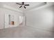 Bright main bedroom featuring tray ceiling, plush carpet, and access to en-suite bathroom at 131 Prominence Ct, Canton, GA 30114