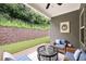 Comfortable covered patio with wicker furniture and a view of a landscaped yard at 131 Prominence Ct, Canton, GA 30114