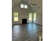 Bright living room with a fireplace, high ceilings, and light wood-look flooring at 204 Saratoga Dr, Acworth, GA 30102