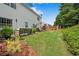 Lush backyard featuring green grass, plants, and a charming patio area for relaxation and entertainment at 208 Magnolia Leaf Dr, Woodstock, GA 30188