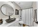 Stylish bathroom with a modern vessel sink, granite counters and decorative mirror at 208 Magnolia Leaf Dr, Woodstock, GA 30188