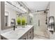 Beautiful bathroom featuring double sinks with marble countertops and a tiled walk-in shower at 208 Magnolia Leaf Dr, Woodstock, GA 30188