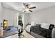 Neutral-toned bedroom with a cozy daybed, workspace, and a bright window at 208 Magnolia Leaf Dr, Woodstock, GA 30188