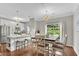 Bright dining area with a modern chandelier and hardwood floors at 208 Magnolia Leaf Dr, Woodstock, GA 30188