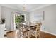 Cozy dining area featuring hardwood floors, natural light, and neutral decor at 208 Magnolia Leaf Dr, Woodstock, GA 30188
