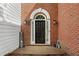 Elegant front door with decorative trim and sidelights, set in a brick facade at 208 Magnolia Leaf Dr, Woodstock, GA 30188