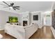Cozy living room with a fireplace, modern ceiling fan, and an inviting sofa at 208 Magnolia Leaf Dr, Woodstock, GA 30188