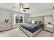 Serene main bedroom with large bed, elegant decor, and bright window with neighborhood views at 208 Magnolia Leaf Dr, Woodstock, GA 30188