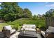 Relaxing outdoor patio with cozy seating and lush green surroundings, perfect for entertaining at 208 Magnolia Leaf Dr, Woodstock, GA 30188