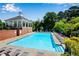 Community pool with lounge chairs, sun umbrellas and access to the gazebo at 208 Magnolia Leaf Dr, Woodstock, GA 30188