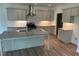 Modern kitchen featuring light gray cabinets, granite countertops, stainless steel appliances, and a spacious island at 208 Saratoga Dr, Acworth, GA 30102
