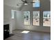 Bright living room with hardwood floors, fireplace, and large windows for natural light at 208 Saratoga Dr, Acworth, GA 30102
