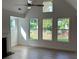 Sun-filled living room boasts vaulted ceilings, large windows, and neutral tones, creating a bright and airy atmosphere at 208 Saratoga Dr, Acworth, GA 30102