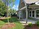 Covered patio overlooking a well-manicured lawn with lush greenery and a privacy fence at 208 Saratoga Dr, Acworth, GA 30102