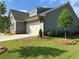 A charming house is seen from the side with a well-kept lawn and beautiful landscaping, trees, and concrete driveway at 208 Saratoga Dr, Acworth, GA 30102