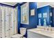 Cheerful bathroom with blue walls, patterned shower curtain, and bright natural light from the window at 2217 Virginia Ne Pl, Atlanta, GA 30305