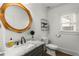 Modern bathroom with marble countertops, decorative mirror, and classic white toilet and sink at 2217 Virginia Ne Pl, Atlanta, GA 30305