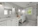 Bright bathroom with marble countertops, double sinks, white cabinetry, and modern fixtures at 2217 Virginia Ne Pl, Atlanta, GA 30305