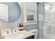 Contemporary bathroom featuring a single sink, a glass shower, and a round mirror at 2217 Virginia Ne Pl, Atlanta, GA 30305