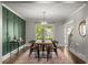 Dining room features paneled accent wall, modern light fixture, and views of the home's stairway at 2217 Virginia Ne Pl, Atlanta, GA 30305