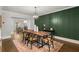 Dining room featuring paneled accent wall, modern light fixture, and wood dining table at 2217 Virginia Ne Pl, Atlanta, GA 30305