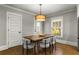 This dining room features a modern light fixture, dining table, and comfortable seating at 2217 Virginia Ne Pl, Atlanta, GA 30305