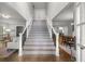 Bright foyer with staircase, hardwood floors, and views into living and dining areas at 2217 Virginia Ne Pl, Atlanta, GA 30305