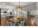 Open-concept kitchen with white cabinets, stainless steel appliances, island, and dining area views at 2217 Virginia Ne Pl, Atlanta, GA 30305