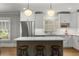 A stylish kitchen with white cabinets, stainless steel appliances, an island, and hardwood floors at 2217 Virginia Ne Pl, Atlanta, GA 30305