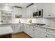 A well-lit kitchen with subway tile backsplash, granite countertops, and stainless steel appliances at 2217 Virginia Ne Pl, Atlanta, GA 30305